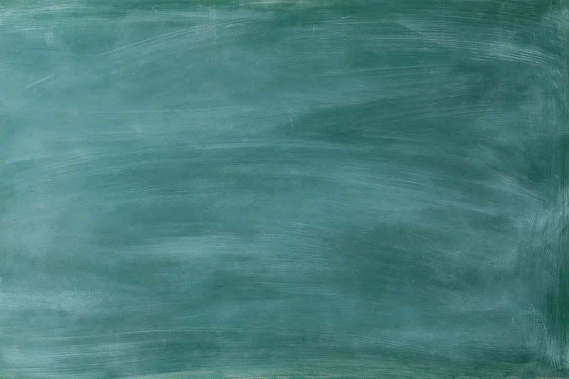 Blank green chalkboard surface with faint chalk residue and texture, no writing or marks, used in educational settings