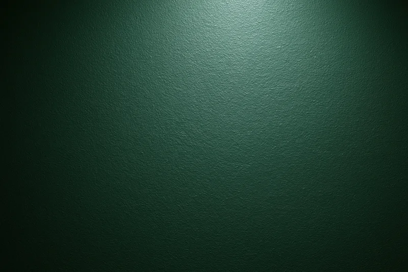 Close-up flat shot of a dark forest green painted wall surface with visible texture and matte finish