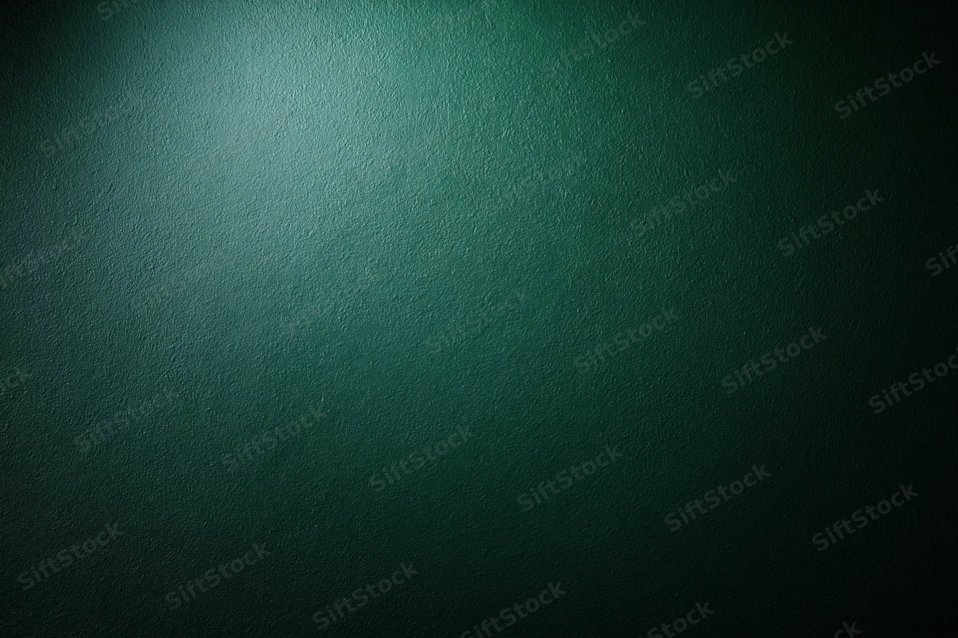 Dark forest green painted wall surface in close-up flat view