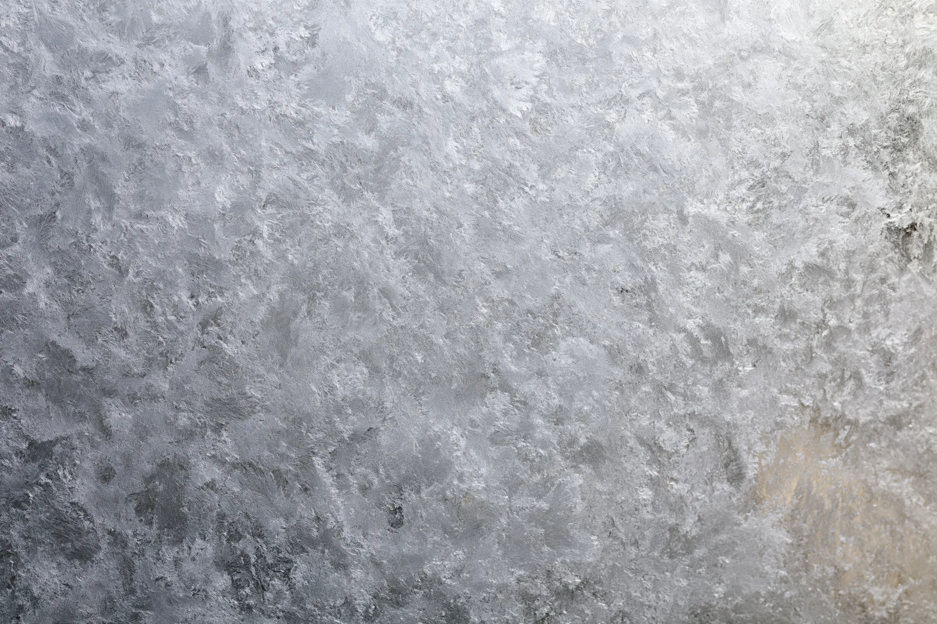 Frosted glass surface with icy texture in close-up flat view