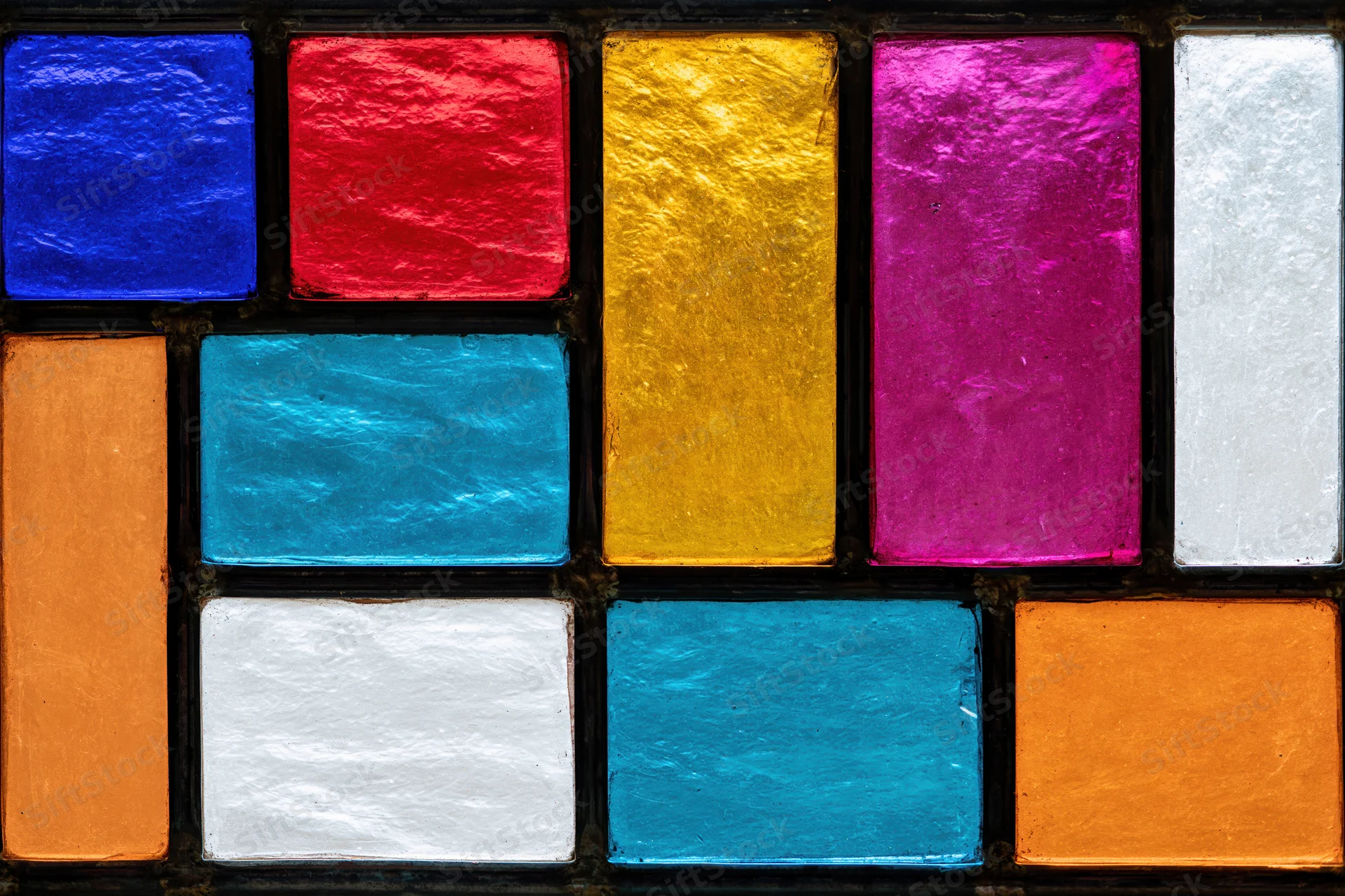Geometric stained glass window with colorful rectangular panels arranged in a grid pattern