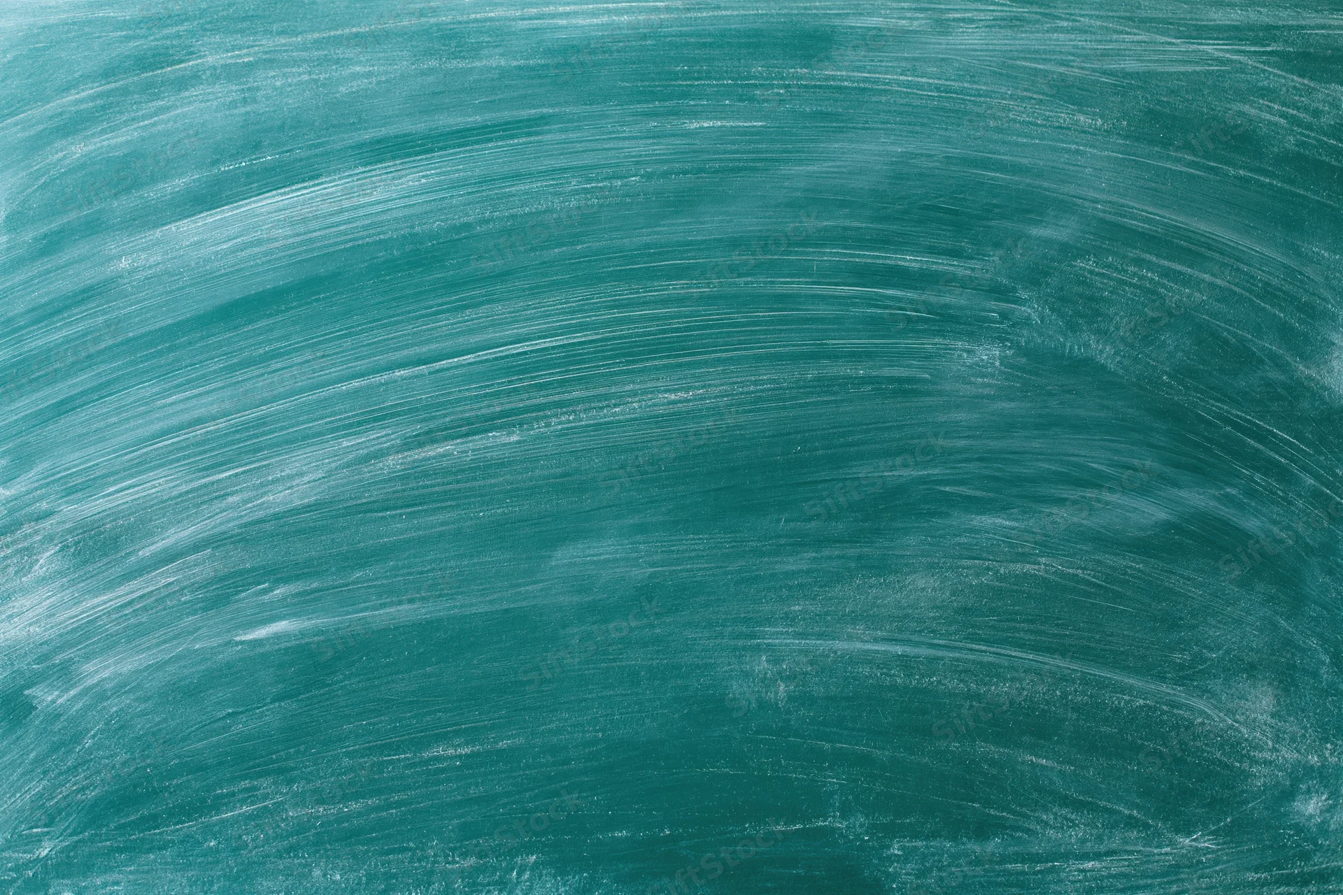 Close-up of a green chalkboard surface with smudged white chalk residue after erasing