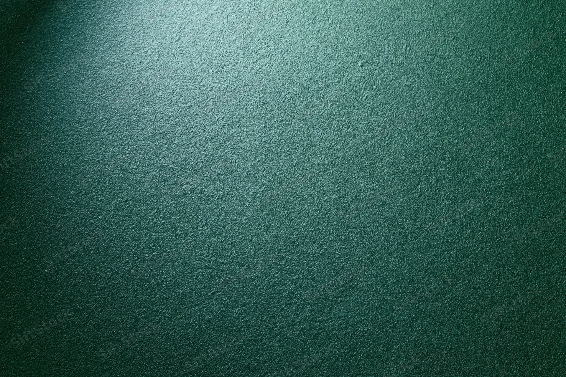 Matte green painted wall surface in close-up flat view