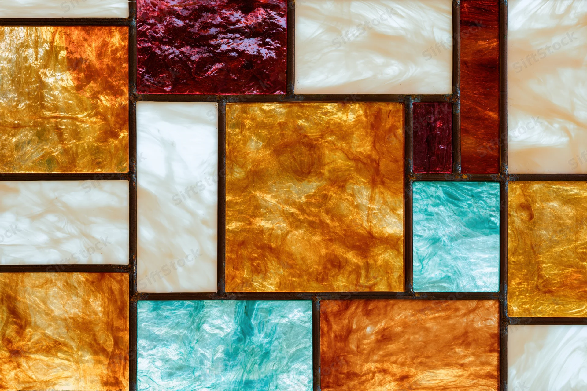 Close-up of a stained glass window panel with colorful translucent glass pieces arranged in a mosaic pattern