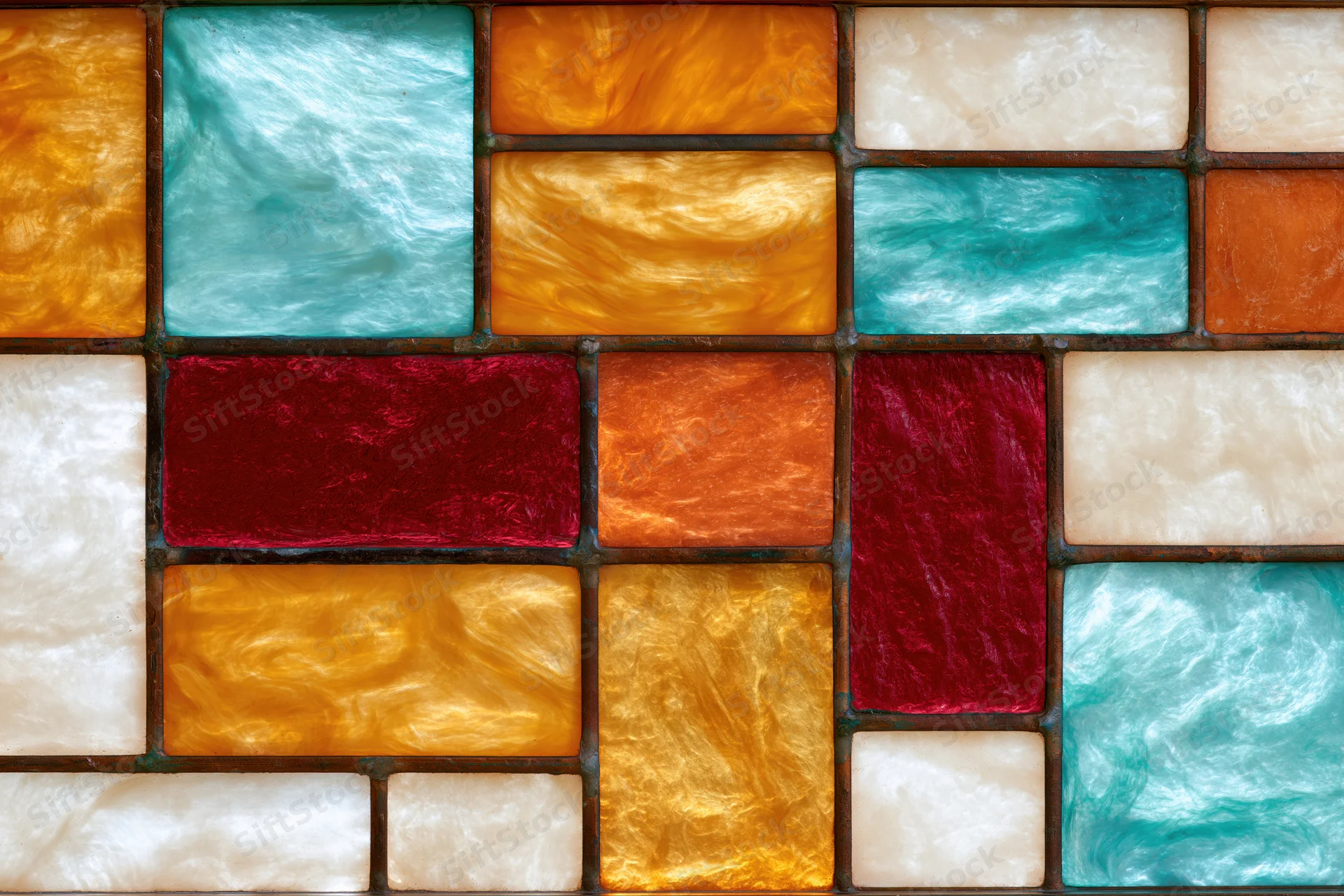 Close-up of a stained glass window panel arranged in a grid pattern with colorful translucent tiles