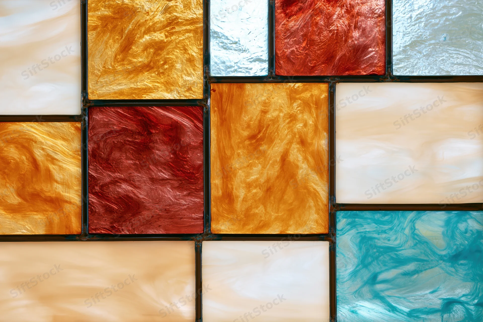 Close-up of a stained glass window panel arranged in a grid pattern with colorful translucent tiles
