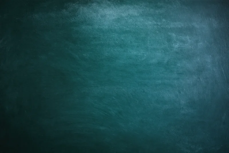 Worn chalkboard surface with smudged green texture showing signs of use and age