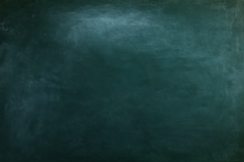 Worn chalkboard surface with smudged residue and dark green texture, flat closeup view