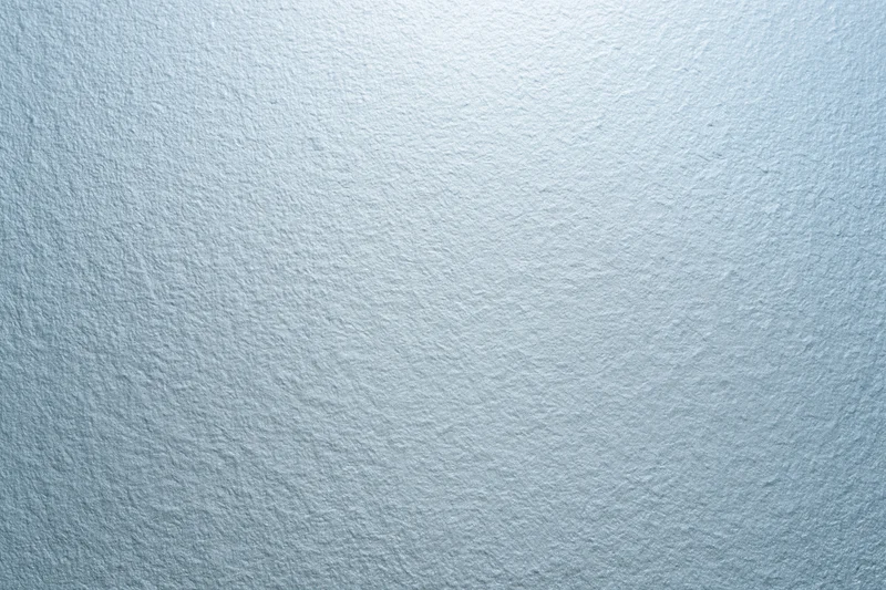 Frosted glass surface with matte white painted texture in close-up flat view