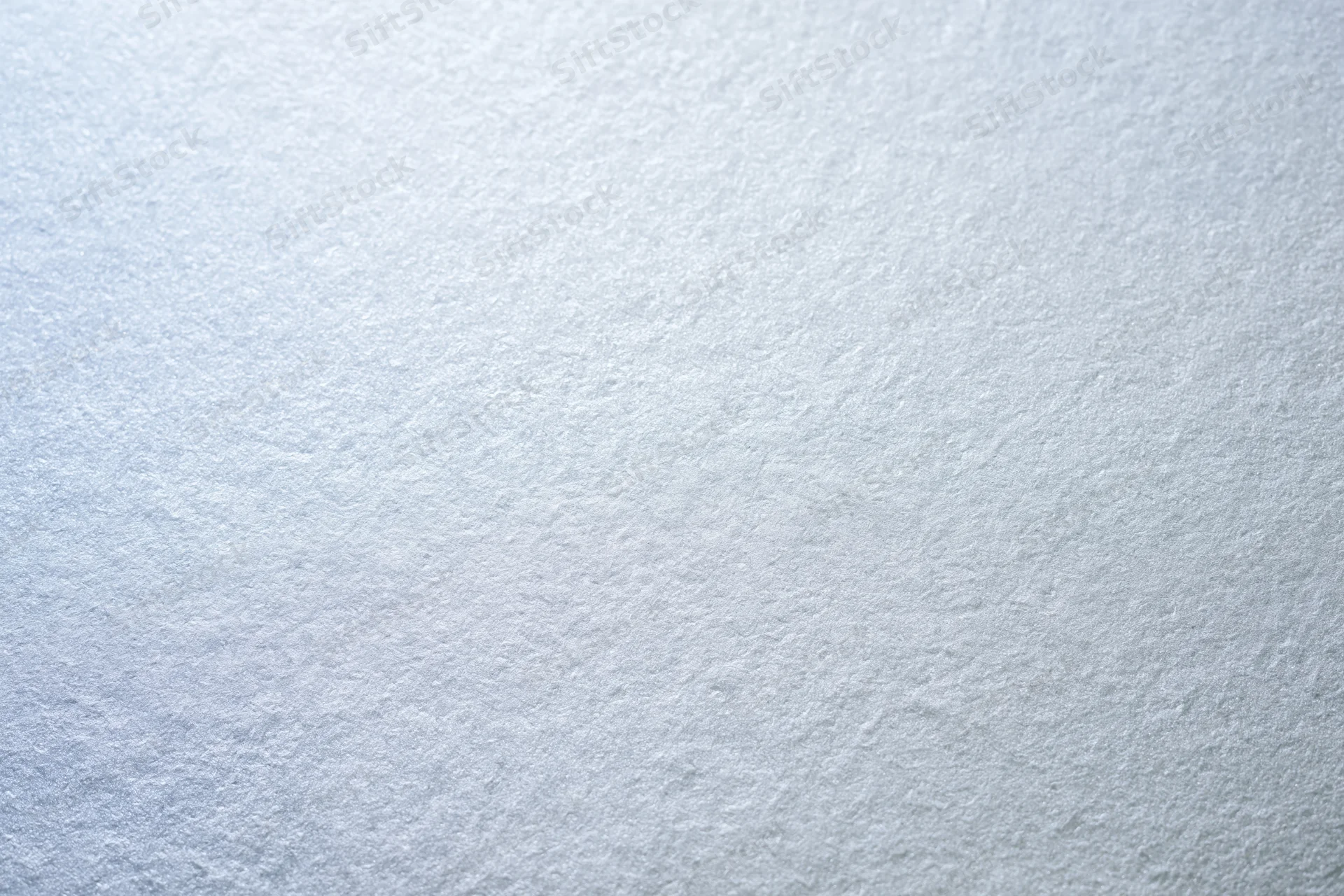 Close-up of frosted glass or matte white painted surface with subtle texture and even lighting