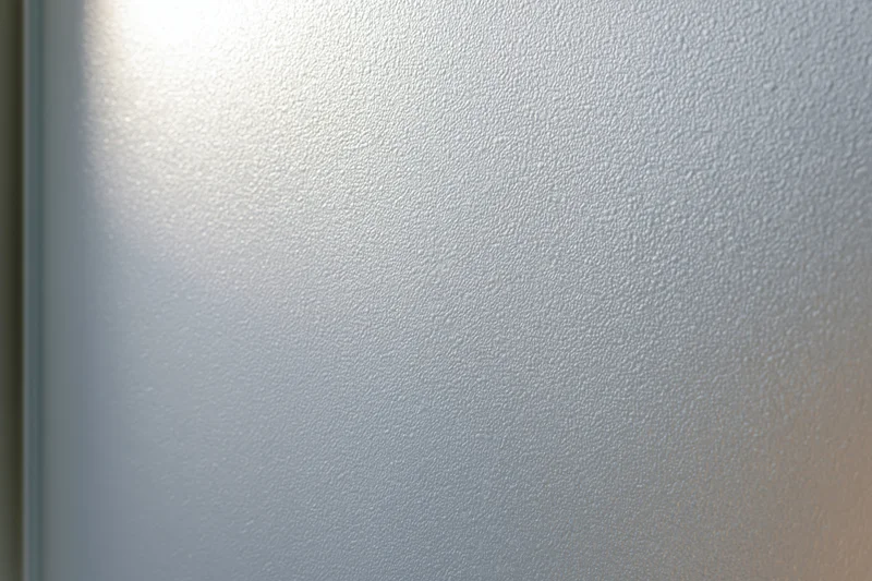 Frosted glass surface with smooth matte texture filling the frame