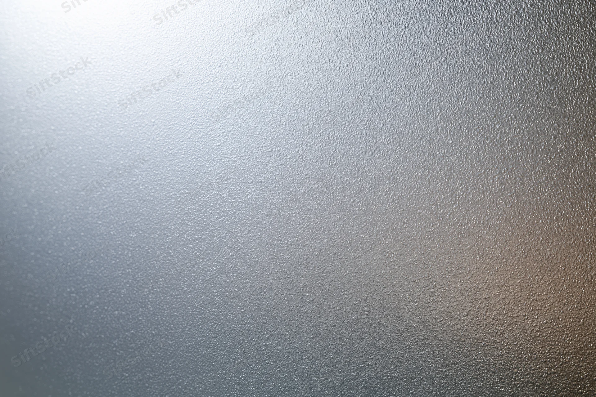 Frosted glass surface with textured pattern filling the frame