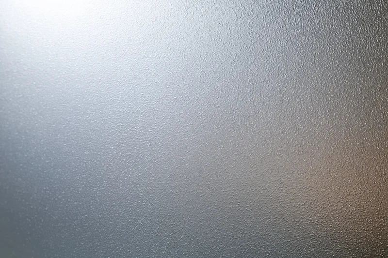 Frosted glass surface with textured pattern filling the frame