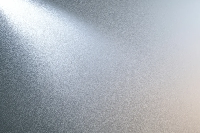 Frosted glass surface with soft light gradient and smooth texture filling the frame