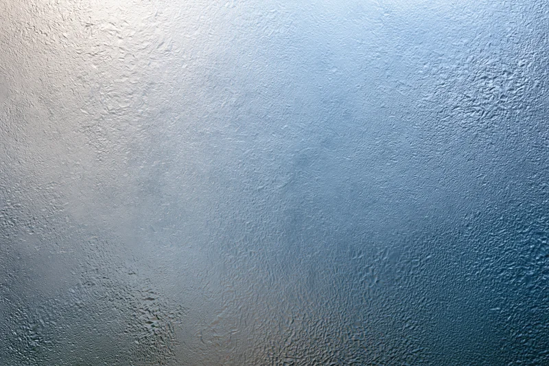 Frosted textured glass surface with blue gradient and light diffusion