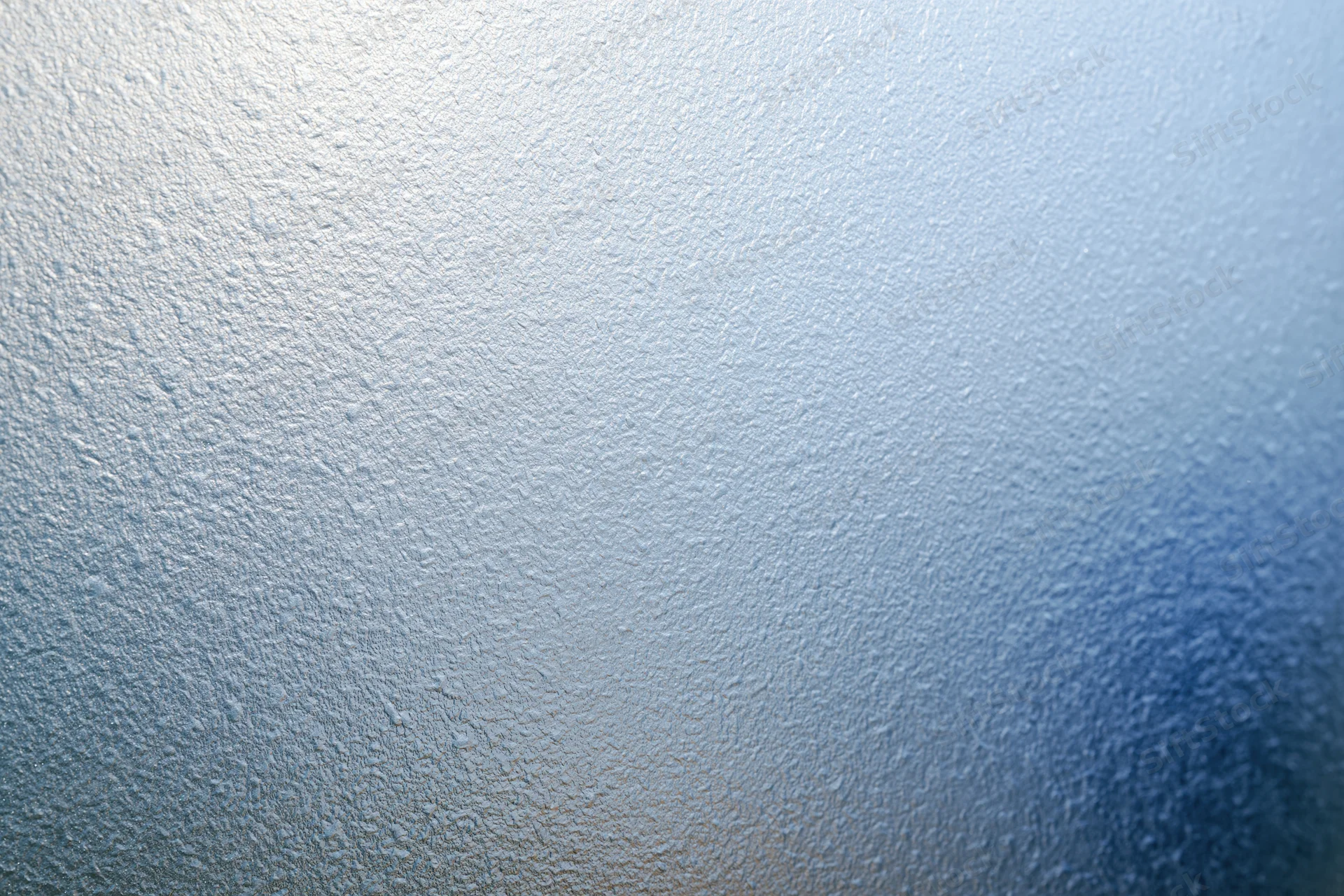 Frosted glass surface with textured pattern and blue gradient background