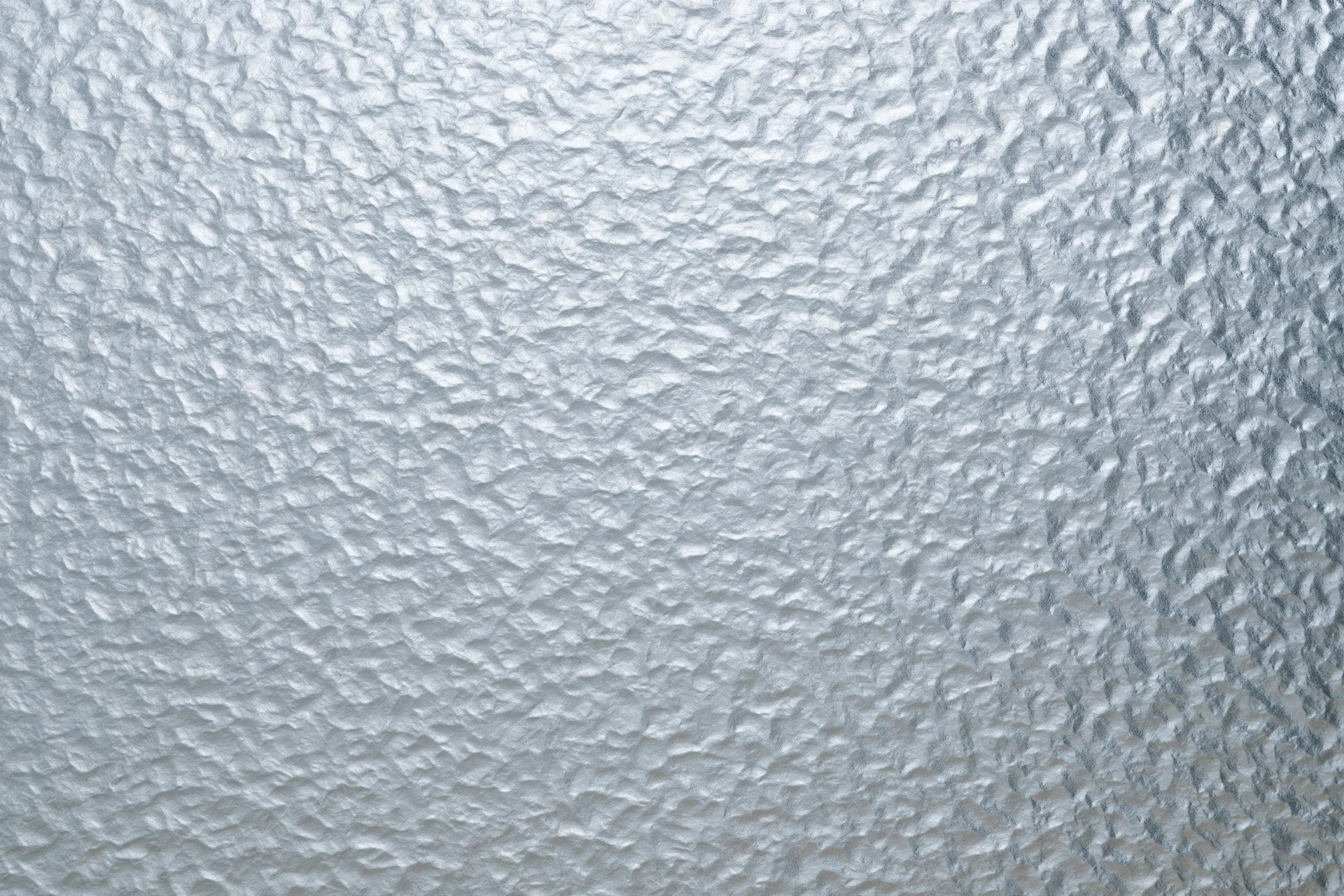 Frosted patterned glass surface filling the frame with textured translucent design