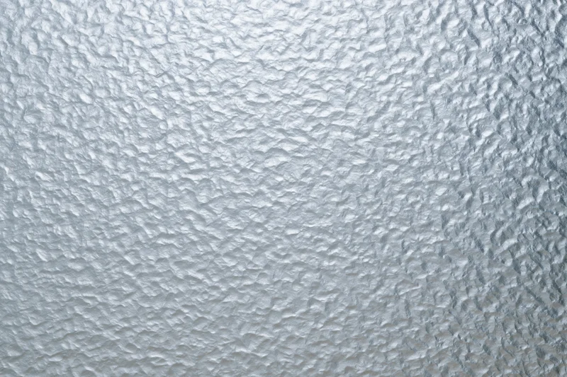 Frosted patterned glass surface filling the frame with textured translucent design