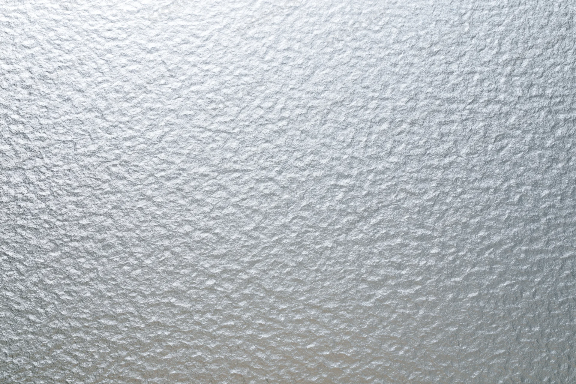 Frosted patterned glass surface filling the frame in a close-up flat shot