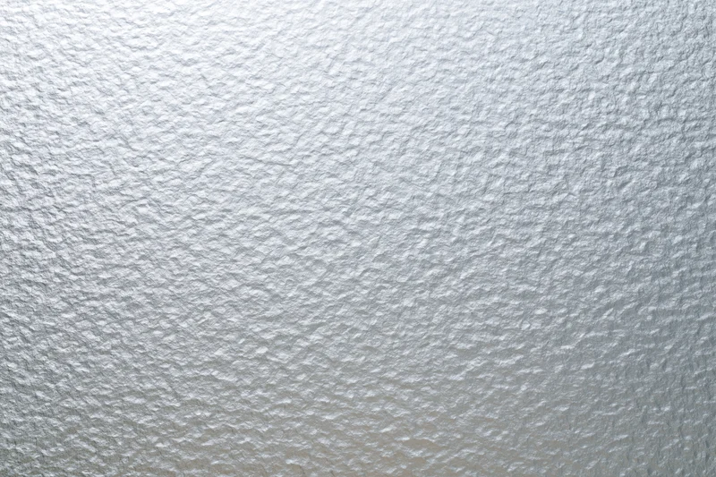 Frosted patterned glass surface filling the frame in a close-up flat shot