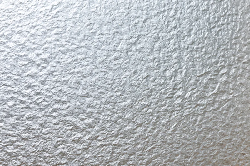 Frosted patterned glass surface filling the frame with textured white translucent finish