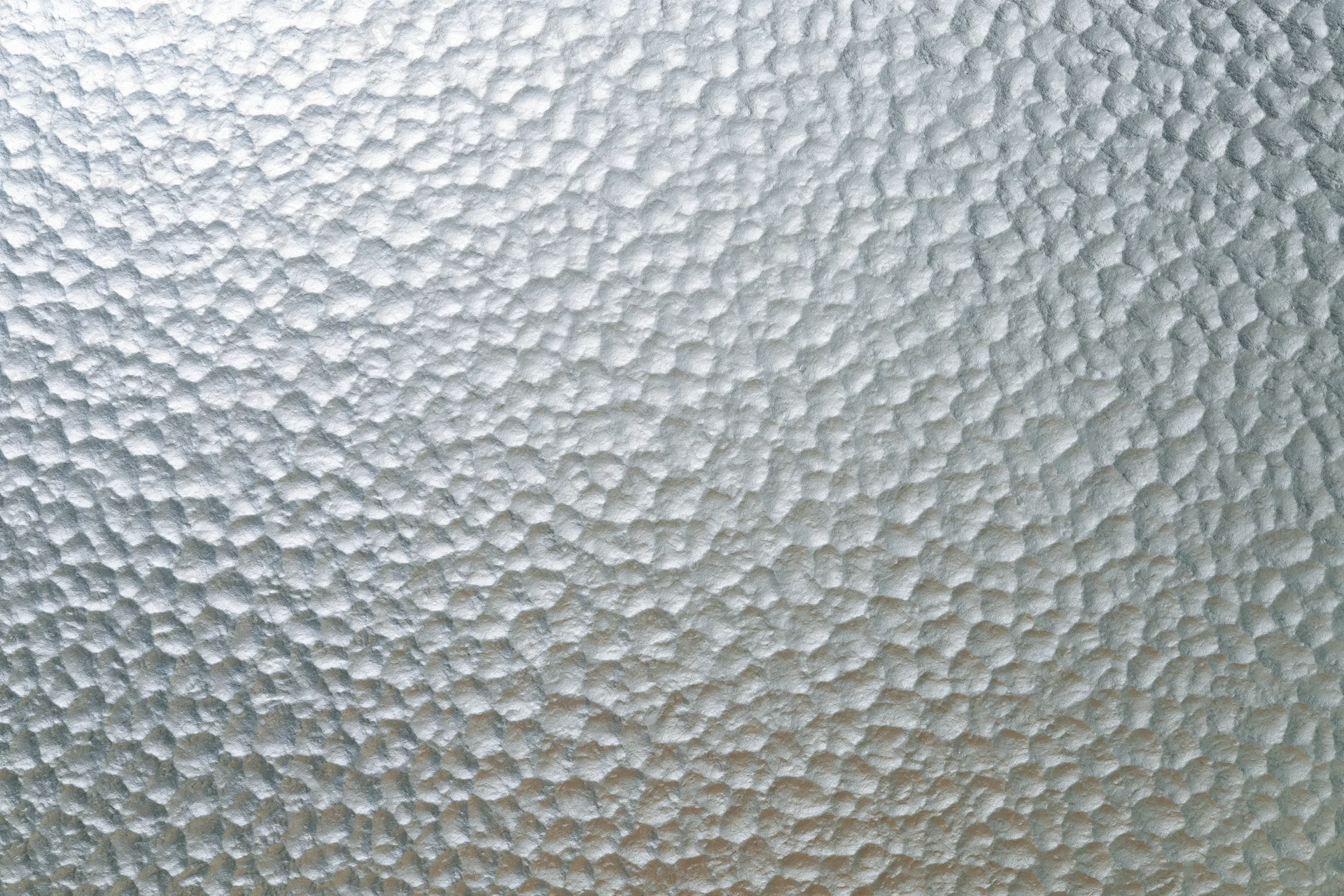 Frosted patterned glass surface filling the frame with a hexagonal texture
