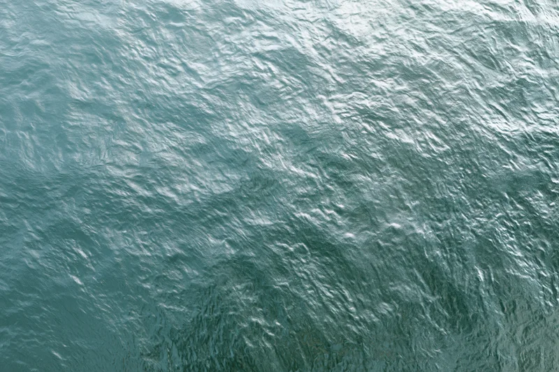 Textured water surface with ripples and light reflections