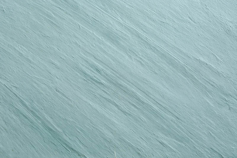 Close-up of a matte painted concrete wall with diagonal brushstroke texture