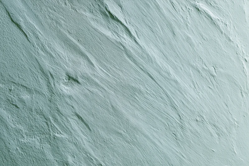 Close-up of matte painted concrete wall surface with visible texture and brushstrokes