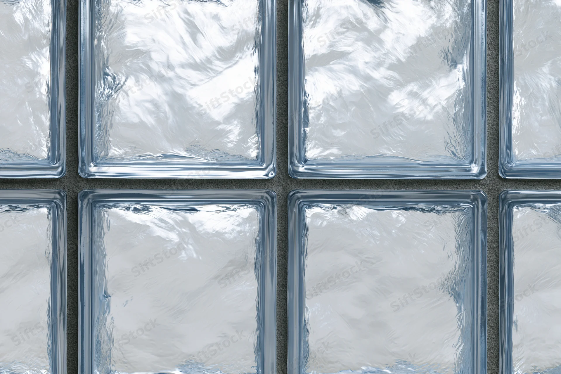 Close-up of a glass block wall arranged in a grid pattern with frosted translucent panels and gray mortar joints