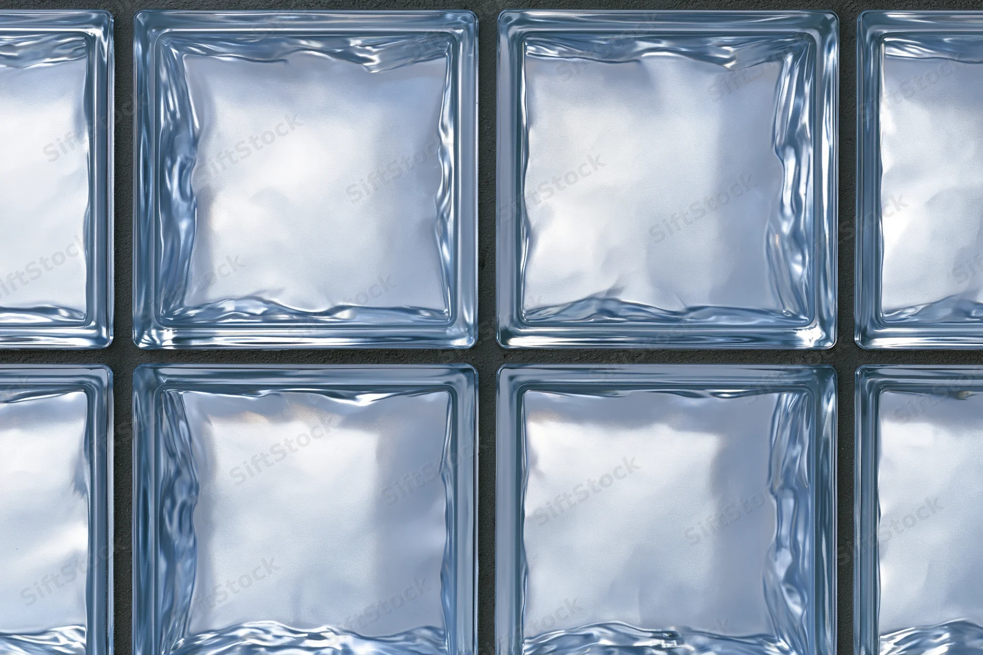 Close-up of a glass block wall arranged in a grid pattern with transparent square panels set in a dark frame