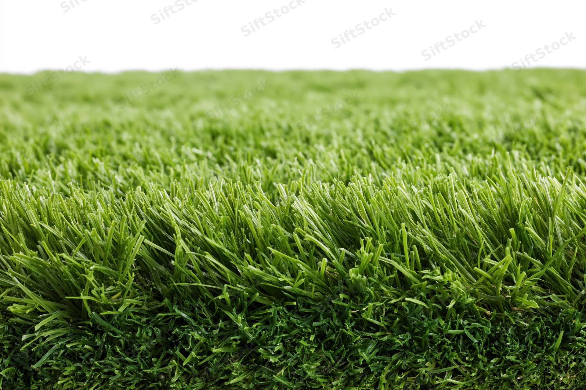 Close-up low-angle view of dense neatly trimmed green artificial grass