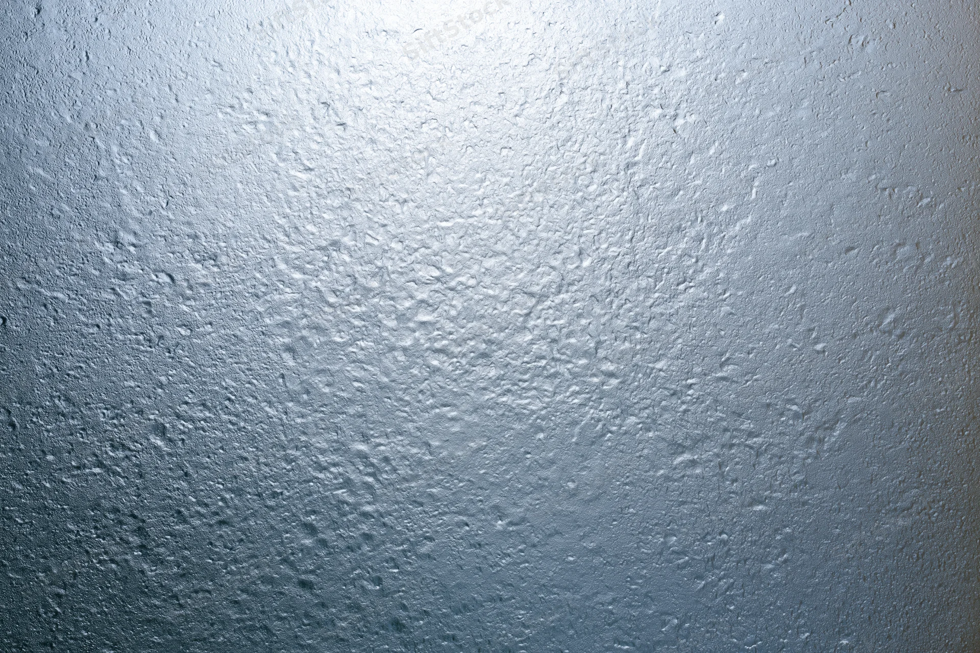 Fogged glass surface covered in fine water droplets from condensation