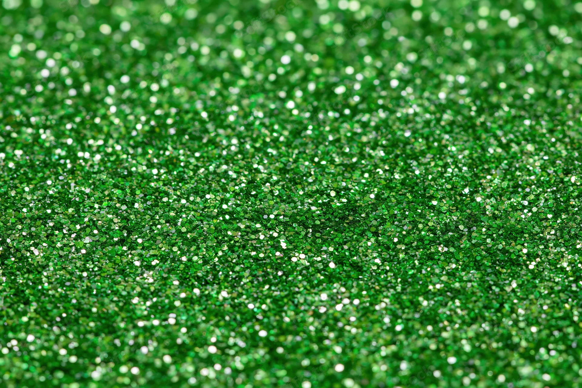 Bright green glitter texture filling the frame in a close-up macro view