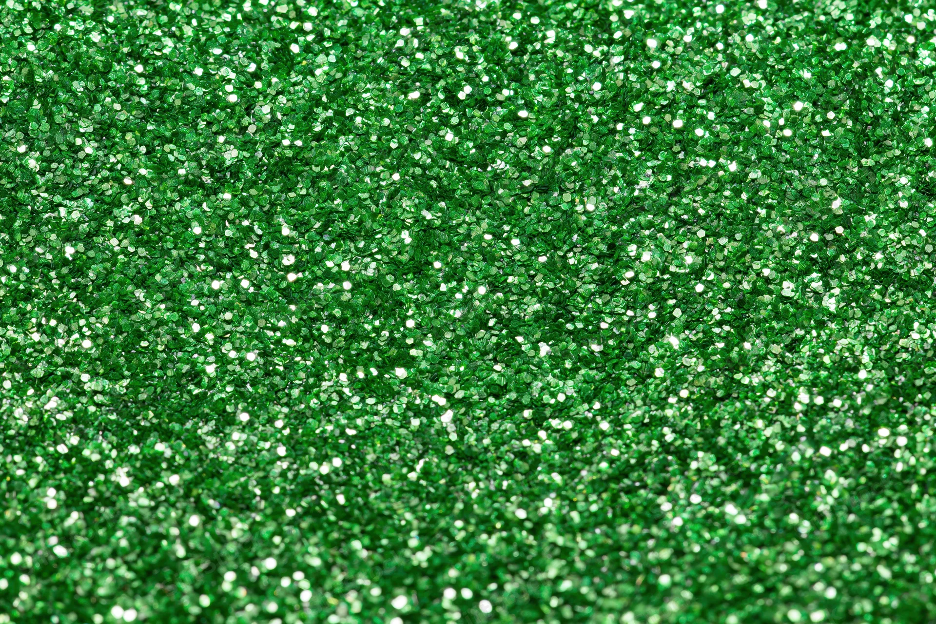 Bright green glitter texture filling the frame in a close-up macro view