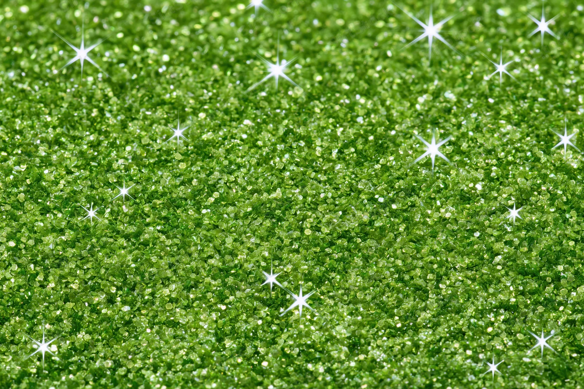 Bright green glitter texture with sparkling highlights filling the frame