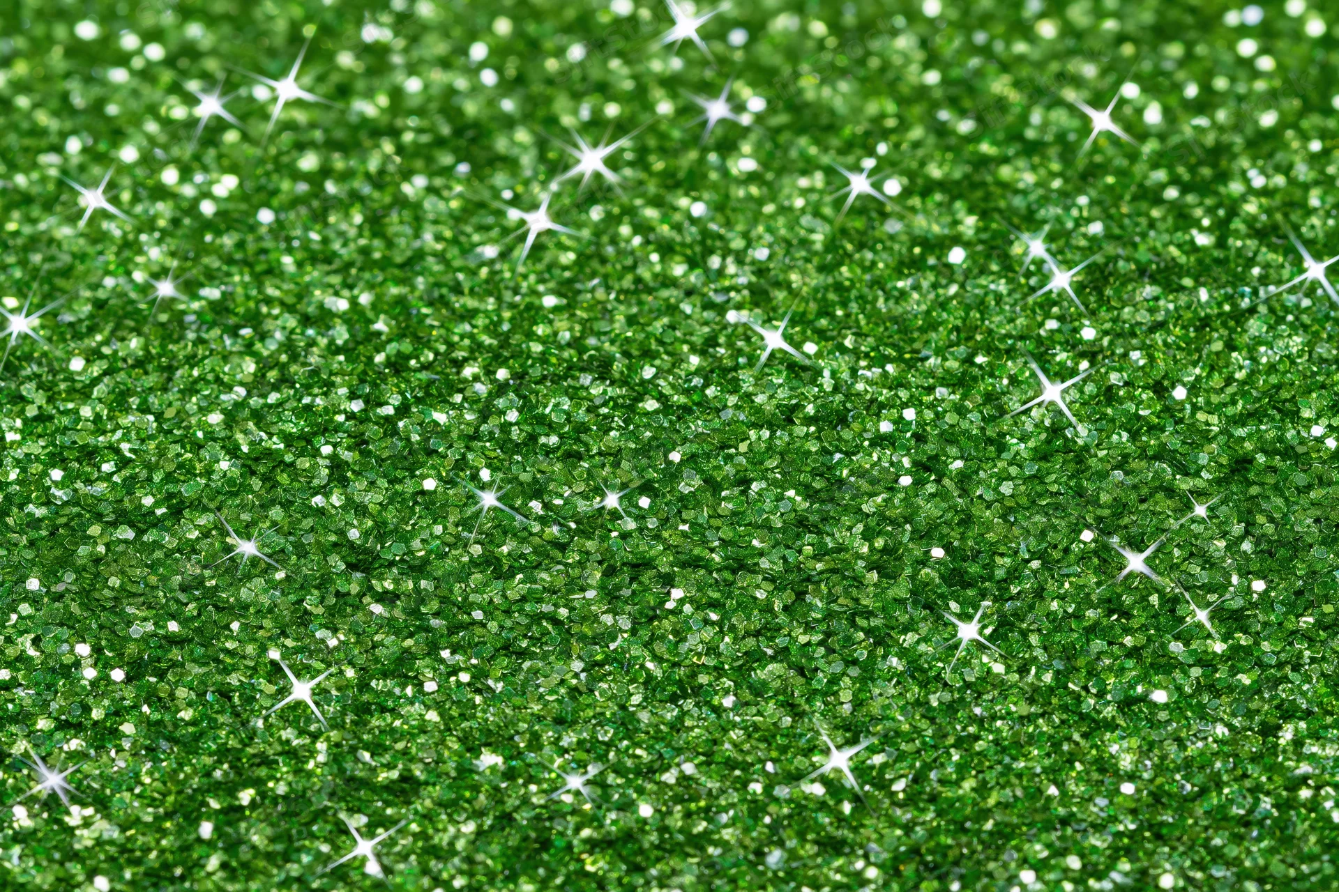 Bright green glitter texture filling the frame with sparkling highlights