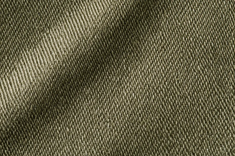 Close-up of olive green twill fabric showing detailed weave texture filling the frame
