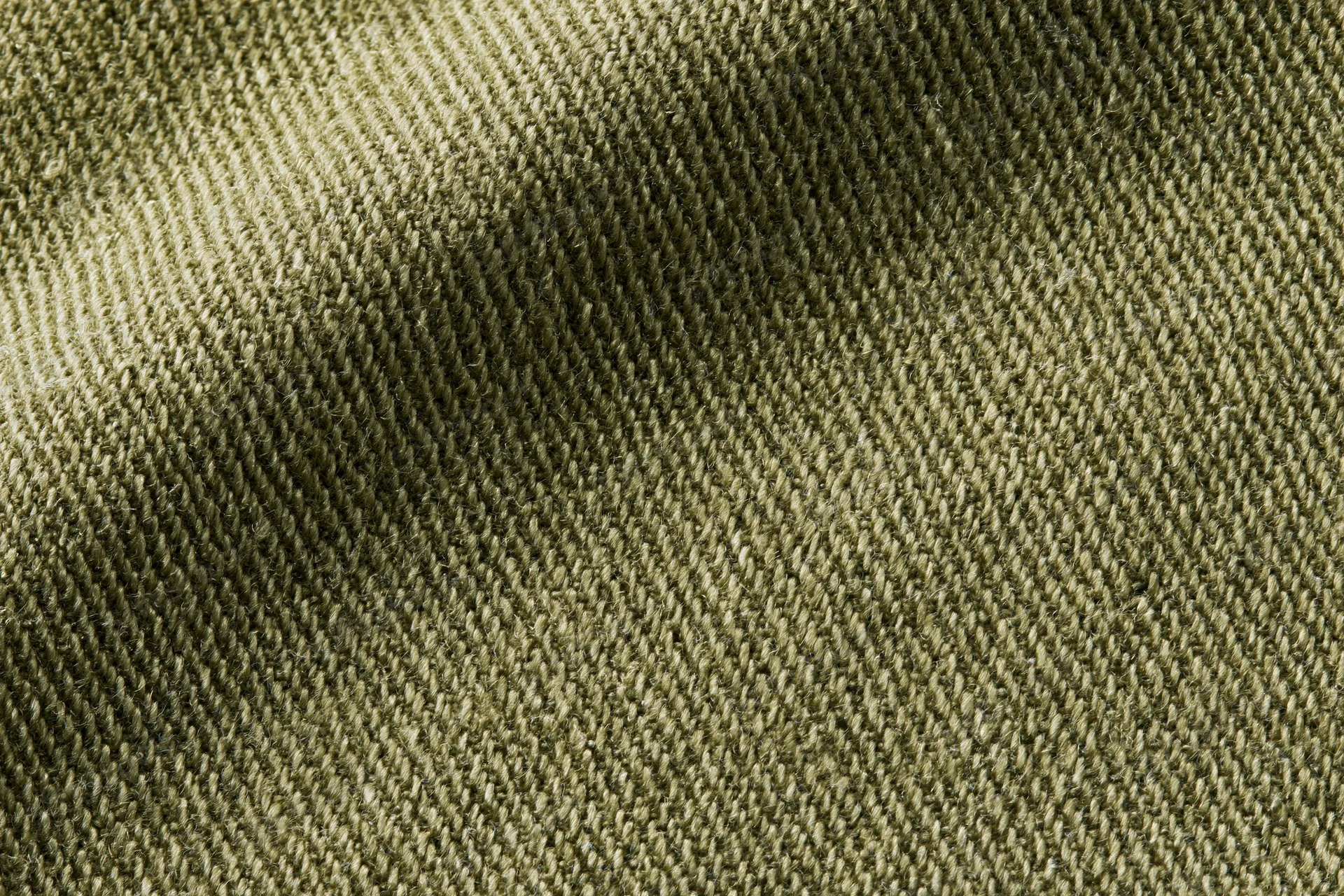 Close-up of olive green twill fabric showing diagonal weave pattern