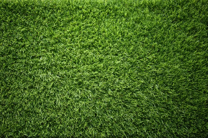 Artificial turf surface filling the frame in overhead closeup view
