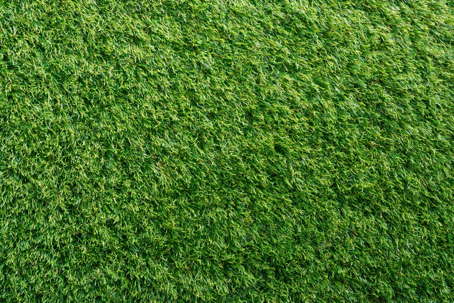 Dense short-cut artificial turf viewed from overhead, forming a uniform green surface