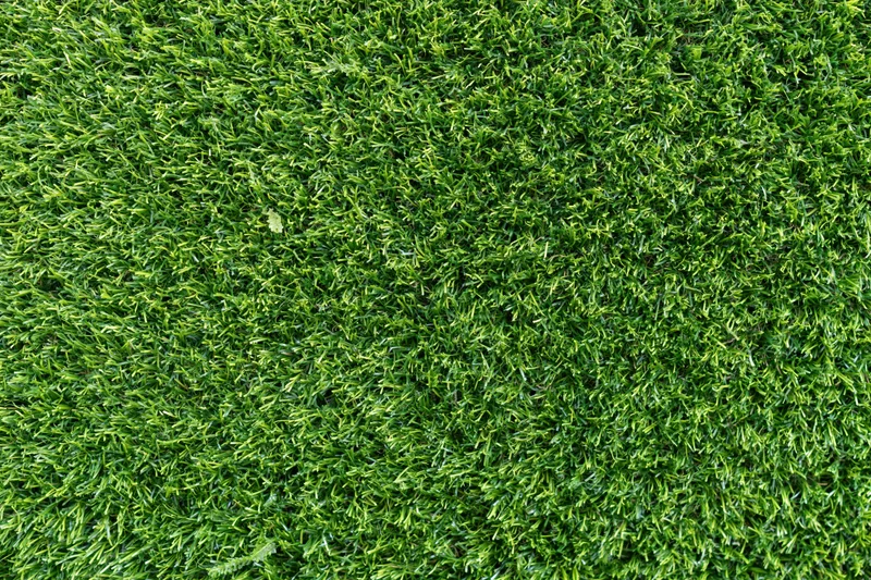 Dense short-cut artificial turf viewed from overhead, filling the frame as a uniform green surface