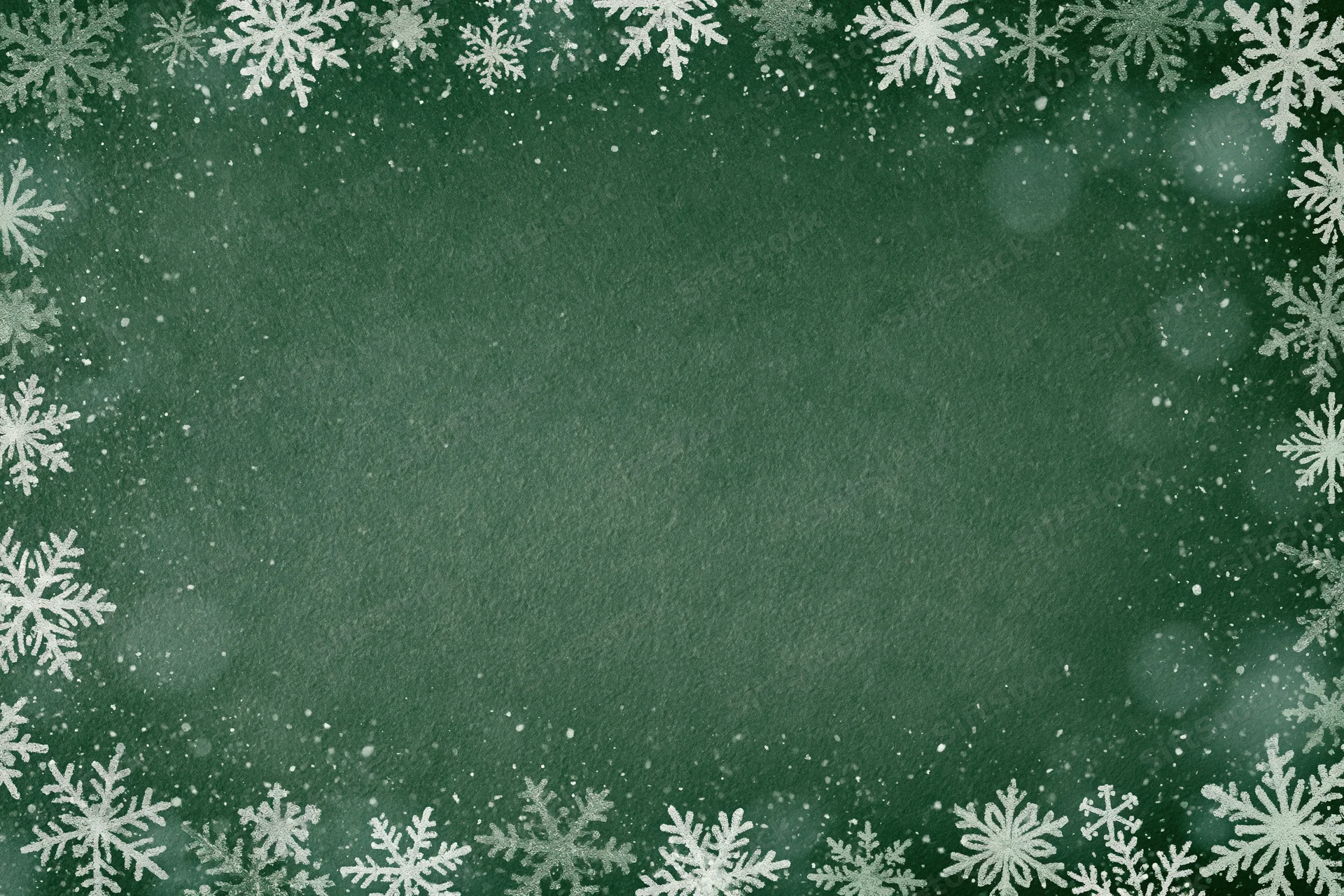 Snowflake border framing a green textured background with bokeh and sparkle for holiday decoration