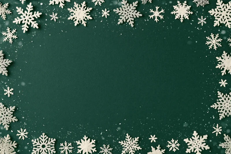 Snowflakes arranged in a border around a green background with copyspace in the center