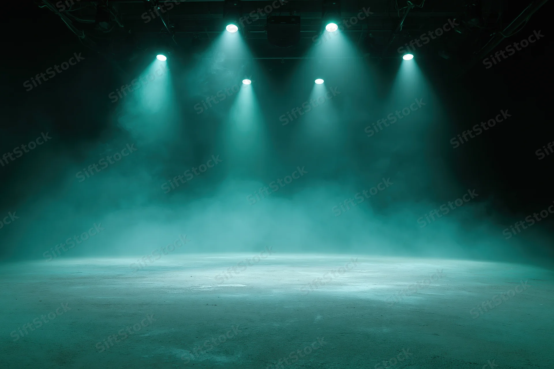 Empty stage floor illuminated by theatrical spotlights in a smoky dark studio