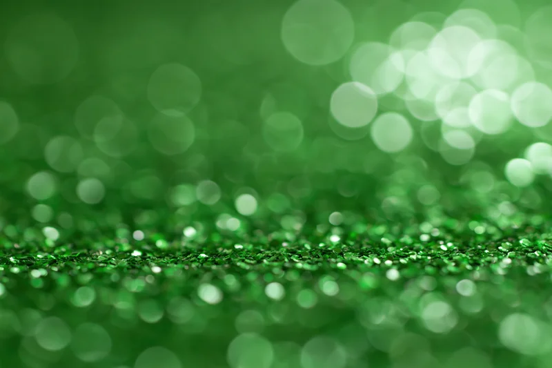 Abstract green glitter surface with bokeh lights and copyspace