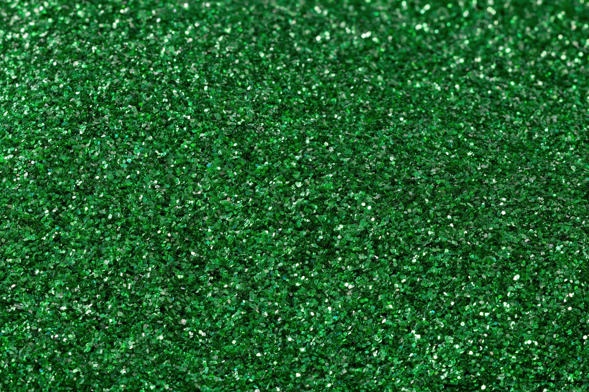 Green glitter surface filling frame in extreme close-up macro view
