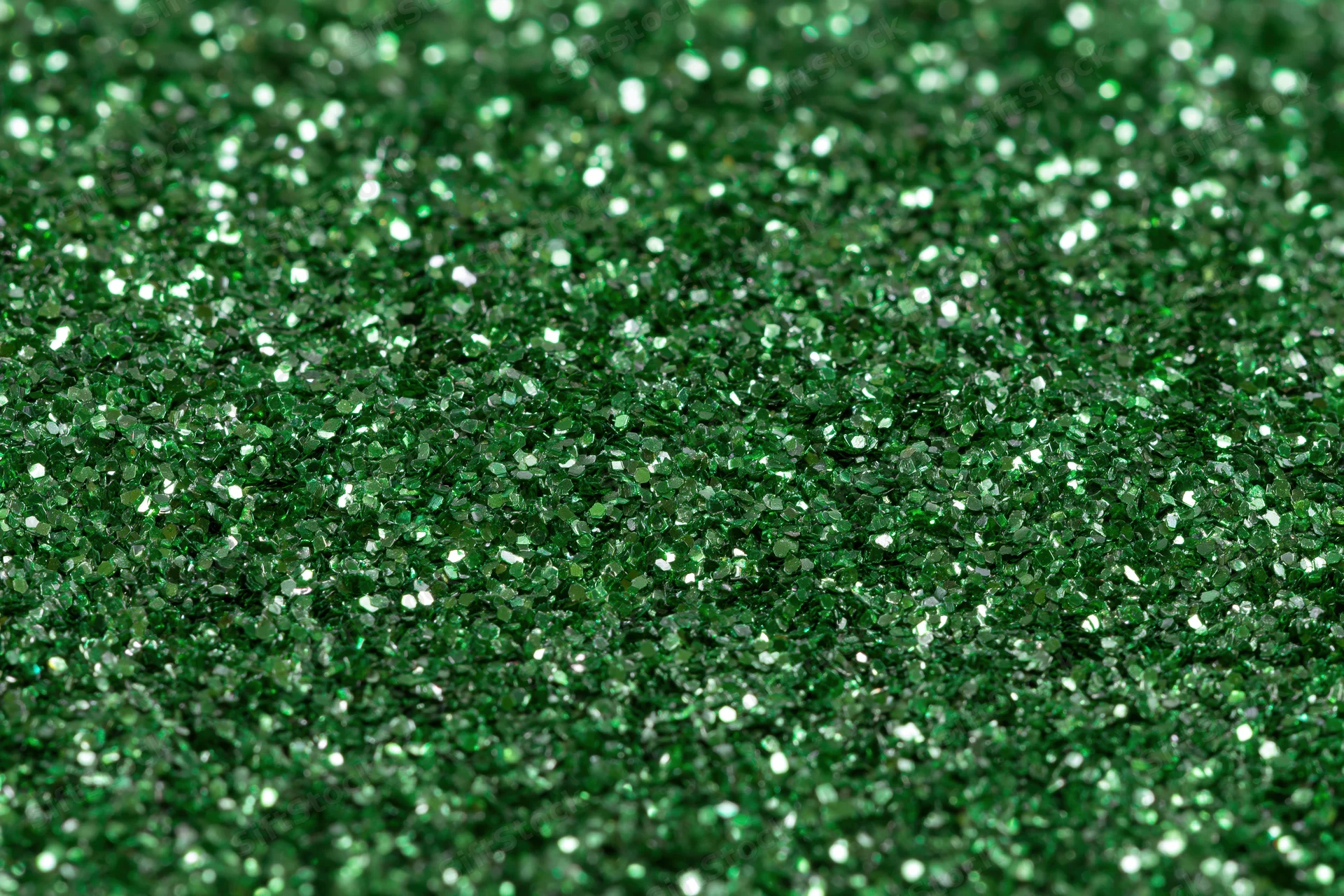 Green glitter surface filling frame in extreme closeup macro view