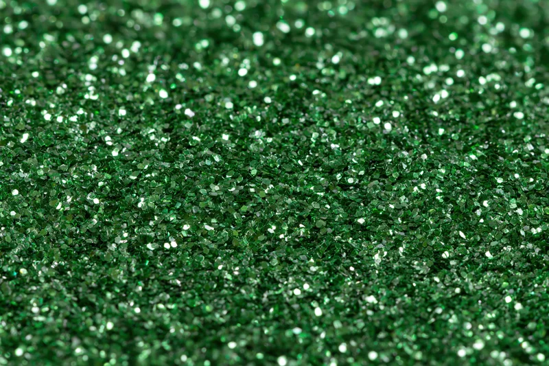 Green glitter surface filling frame in extreme closeup macro view