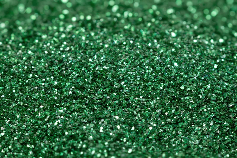 Green glitter surface filling frame in extreme close-up macro view